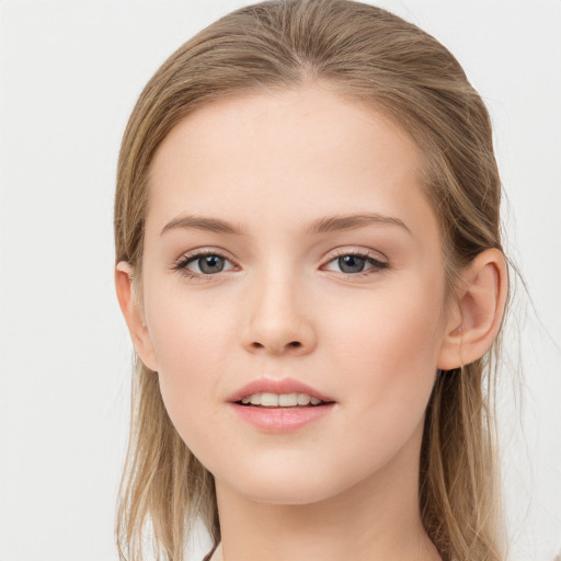 Joyful white child female with long  brown hair and grey eyes