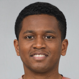 Joyful latino young-adult male with short  brown hair and brown eyes