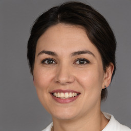 Joyful white young-adult female with medium  brown hair and brown eyes