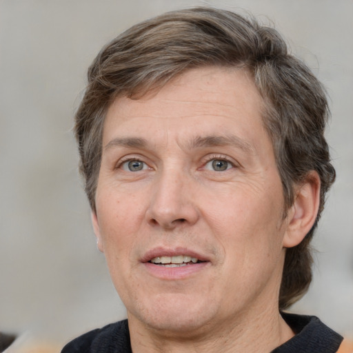 Joyful white adult male with medium  brown hair and grey eyes