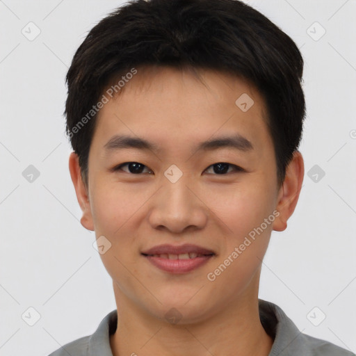 Joyful asian young-adult male with short  black hair and brown eyes