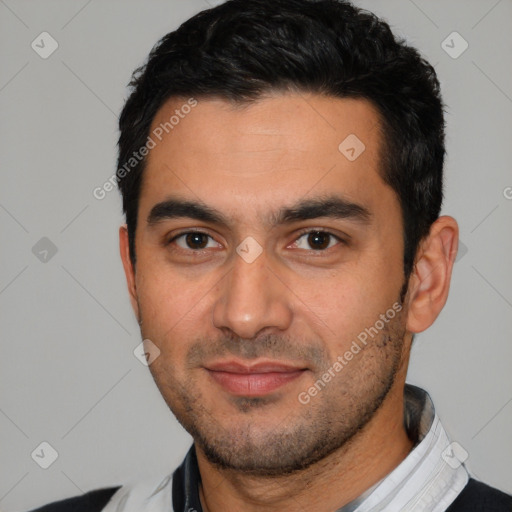 Joyful latino young-adult male with short  black hair and brown eyes