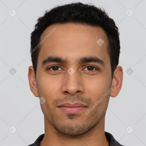 Joyful latino young-adult male with short  black hair and brown eyes