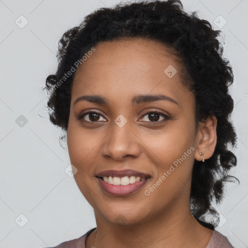 Joyful black young-adult female with long  black hair and brown eyes