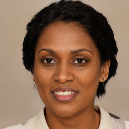 Joyful black adult female with medium  black hair and brown eyes