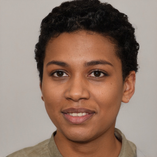 Joyful black young-adult female with short  black hair and brown eyes