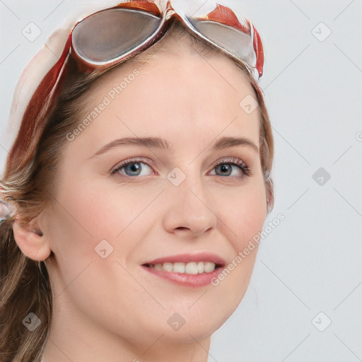 Joyful white young-adult female with long  brown hair and blue eyes