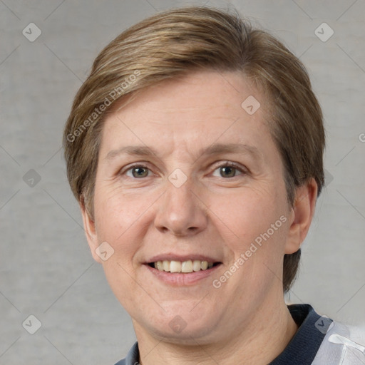 Joyful white adult female with short  brown hair and grey eyes