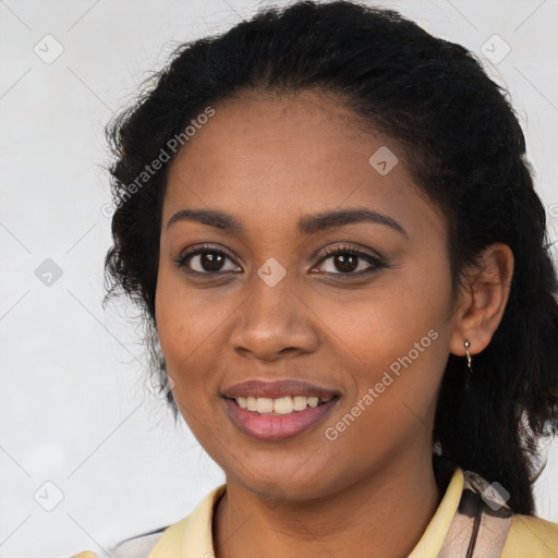 Joyful black young-adult female with long  brown hair and brown eyes