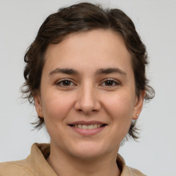 Joyful white young-adult female with medium  brown hair and brown eyes