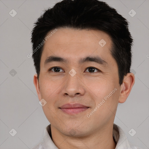 Joyful asian young-adult male with short  black hair and brown eyes