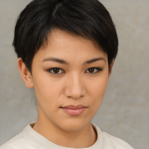 Joyful asian young-adult female with short  brown hair and brown eyes