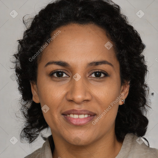 Joyful black adult female with long  brown hair and brown eyes