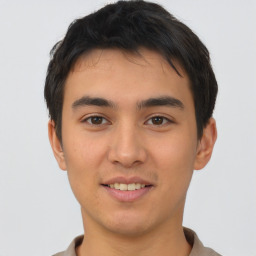 Joyful asian young-adult male with short  brown hair and brown eyes