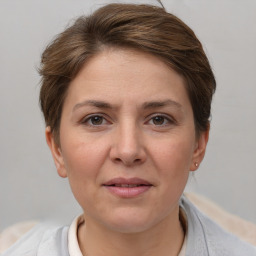 Joyful white adult female with short  brown hair and grey eyes