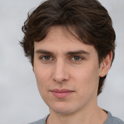 Joyful white young-adult male with medium  brown hair and brown eyes