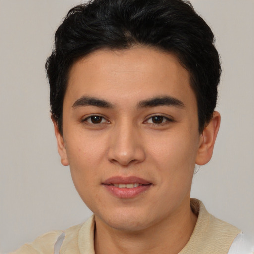 Joyful asian young-adult male with short  brown hair and brown eyes