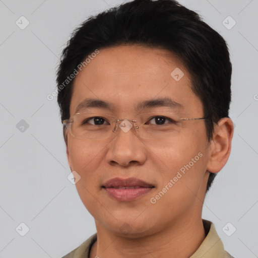 Joyful asian adult male with short  brown hair and brown eyes