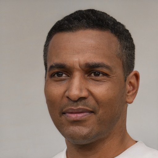 Joyful latino adult male with short  black hair and brown eyes