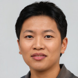 Joyful asian young-adult male with short  black hair and brown eyes