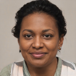 Joyful black adult female with medium  brown hair and brown eyes