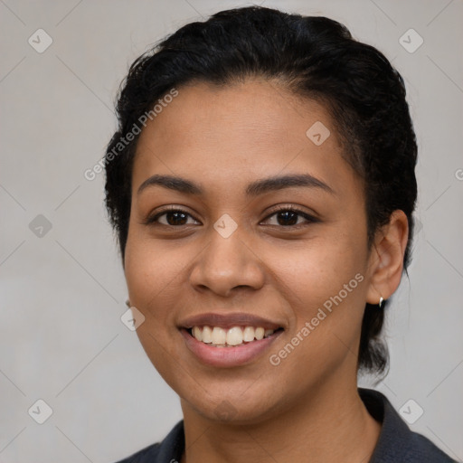 Joyful latino young-adult female with short  black hair and brown eyes