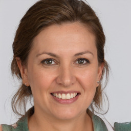 Joyful white adult female with medium  brown hair and grey eyes