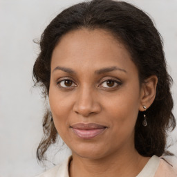 Joyful black adult female with medium  brown hair and brown eyes