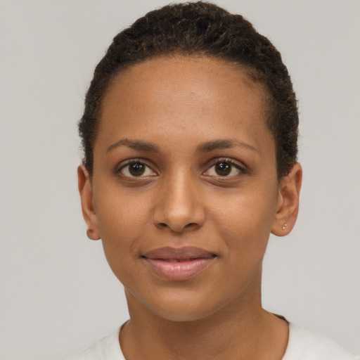 Joyful black young-adult female with short  brown hair and brown eyes