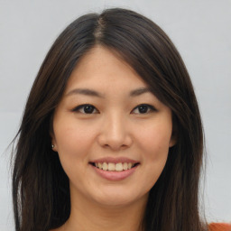 Joyful asian young-adult female with long  brown hair and brown eyes