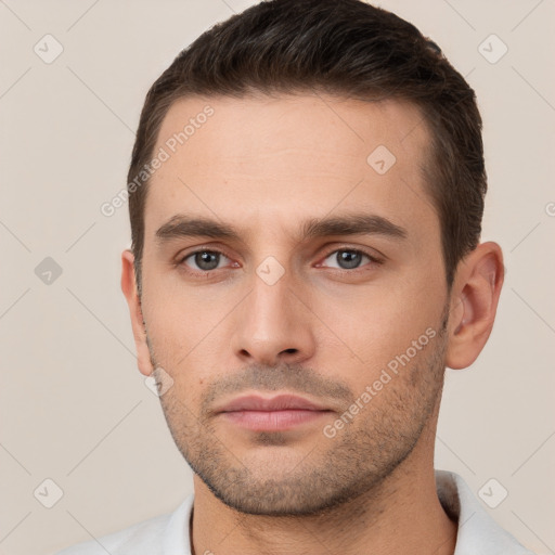 Neutral white young-adult male with short  brown hair and brown eyes