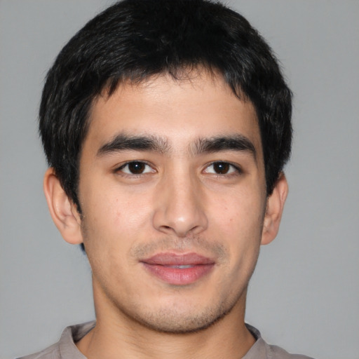 Joyful asian young-adult male with short  black hair and brown eyes