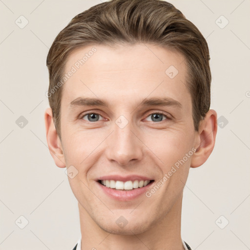 Joyful white young-adult male with short  brown hair and grey eyes