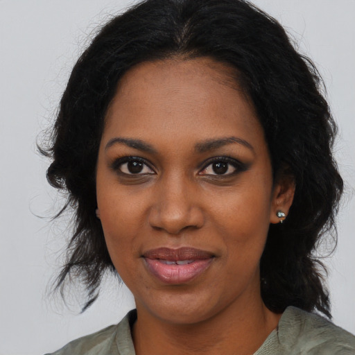 Joyful black young-adult female with medium  brown hair and brown eyes