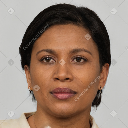 Joyful latino adult female with medium  brown hair and brown eyes