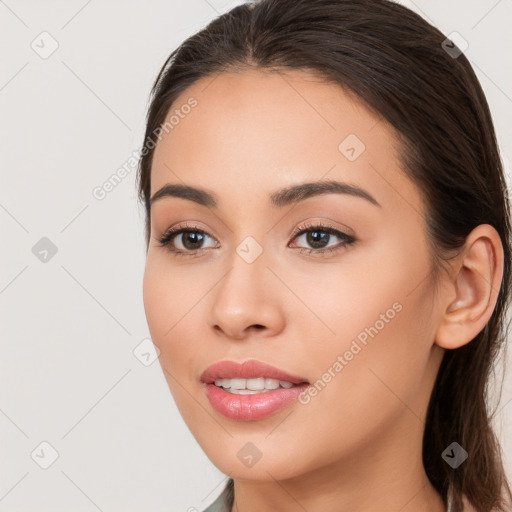 Joyful white young-adult female with long  brown hair and brown eyes