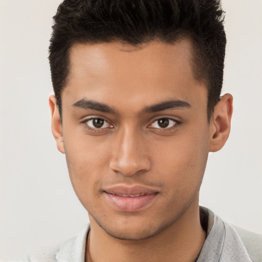 Joyful latino young-adult male with short  brown hair and brown eyes