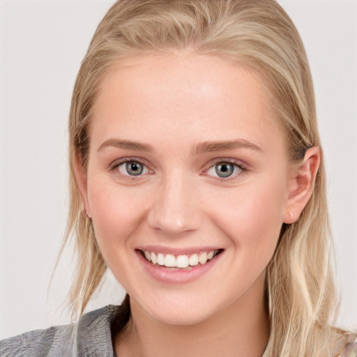 Joyful white young-adult female with medium  brown hair and blue eyes