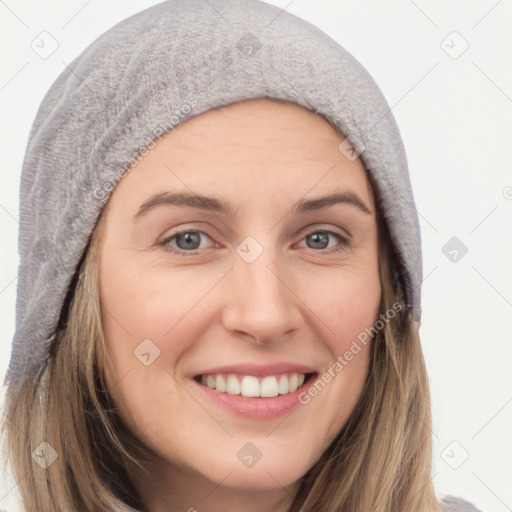 Joyful white young-adult female with long  brown hair and brown eyes