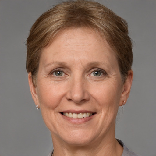 Joyful white adult female with short  brown hair and grey eyes