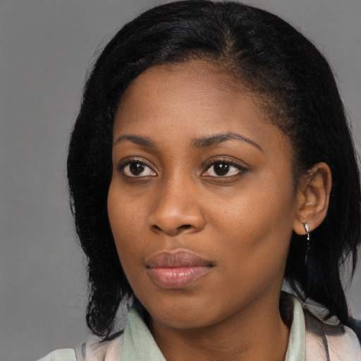 Joyful black young-adult female with medium  black hair and brown eyes
