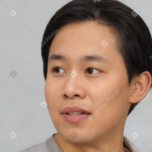 Joyful asian young-adult male with short  black hair and brown eyes