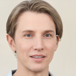 Joyful white young-adult male with short  brown hair and grey eyes