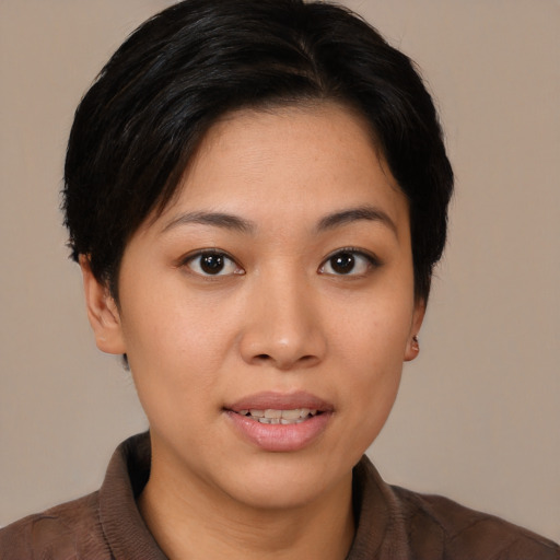 Joyful asian young-adult female with short  black hair and brown eyes