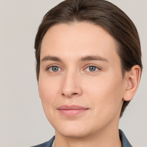 Joyful white young-adult female with short  brown hair and grey eyes