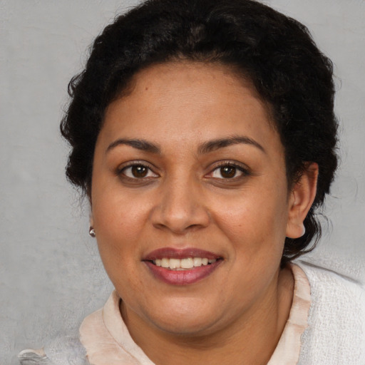 Joyful white adult female with short  brown hair and brown eyes