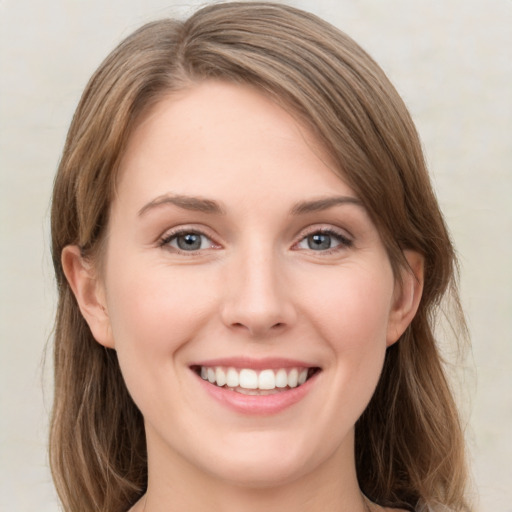 Joyful white young-adult female with medium  brown hair and green eyes