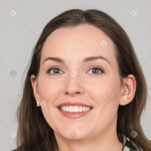 Joyful white young-adult female with long  brown hair and grey eyes