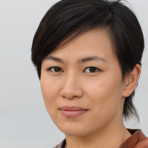 Joyful asian young-adult female with medium  brown hair and brown eyes