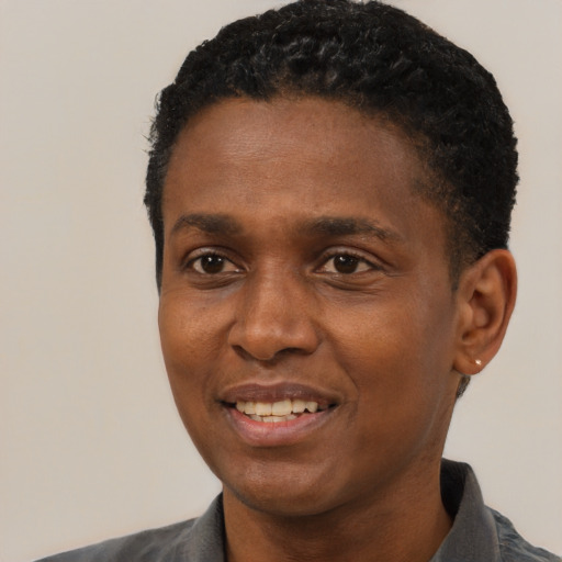 Joyful black young-adult male with short  black hair and brown eyes